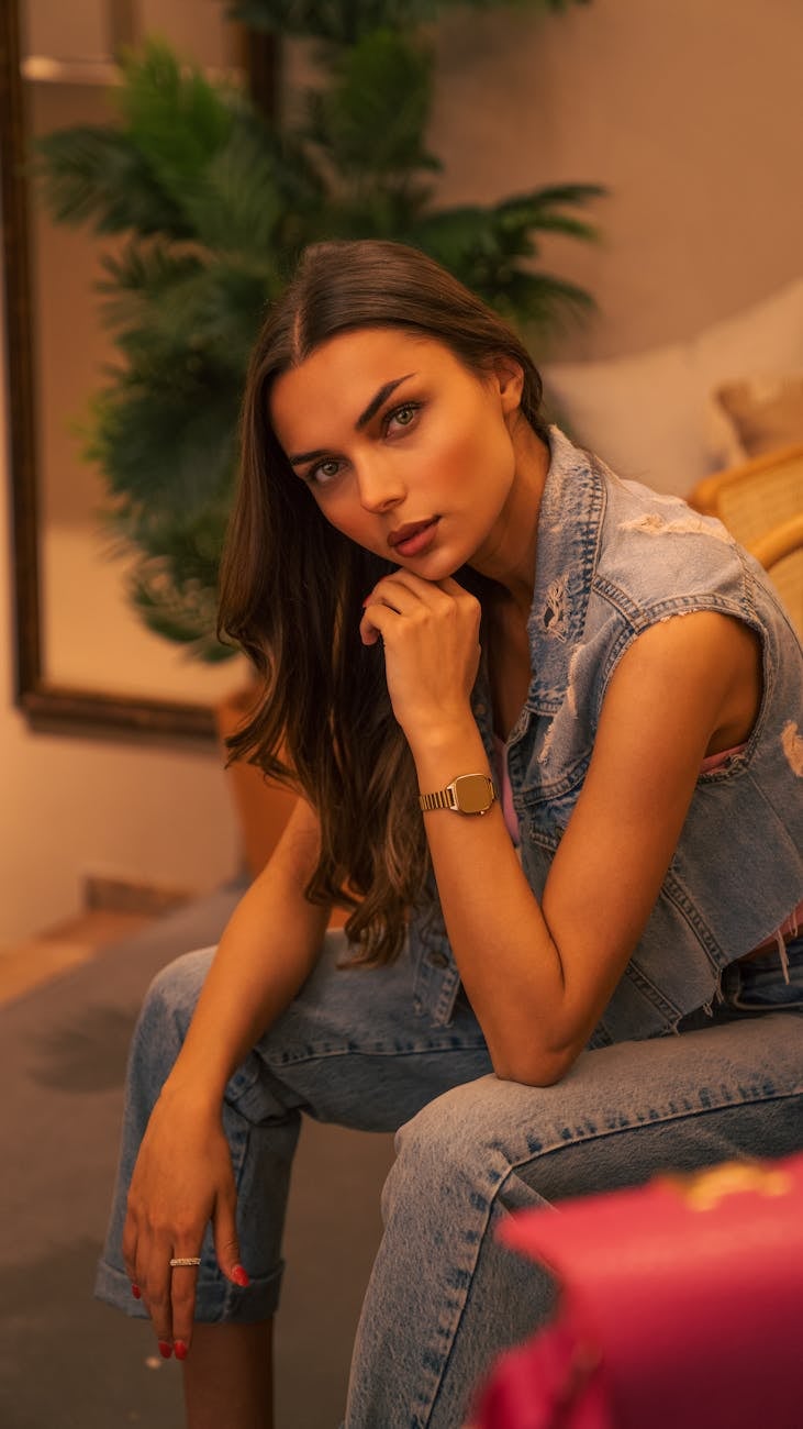 brunette woman in jean vest sitting